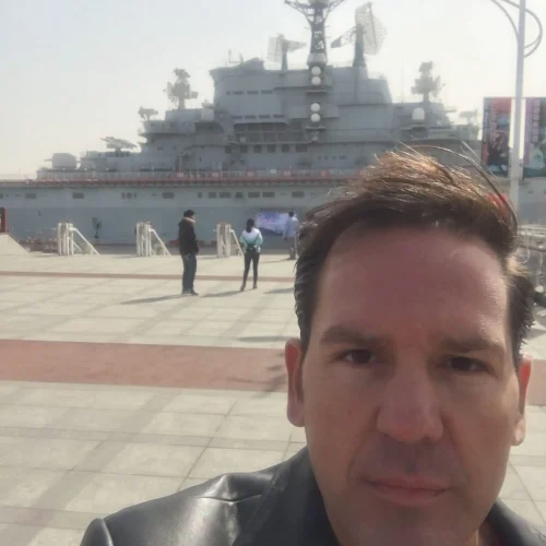 Author Lance Hoovestal standing with the ship